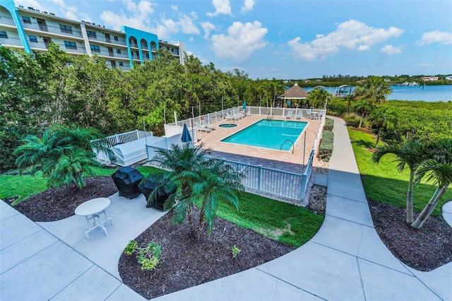 pool with a gazebo, a patio, and fence