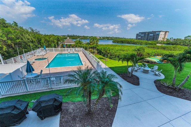 pool featuring a fenced backyard, a gazebo, a patio, and a lawn
