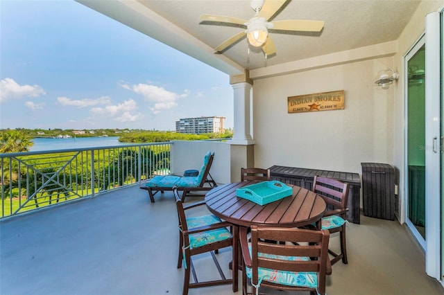 balcony with a water view and ceiling fan
