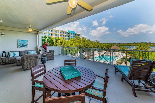 balcony with an outdoor living space and ceiling fan