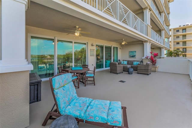 view of patio with a ceiling fan, an outdoor living space, and a balcony