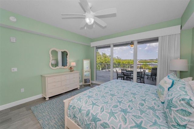 bedroom featuring a ceiling fan, baseboards, access to exterior, and wood finished floors