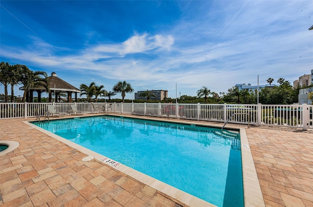 community pool featuring a patio, a gazebo, and fence