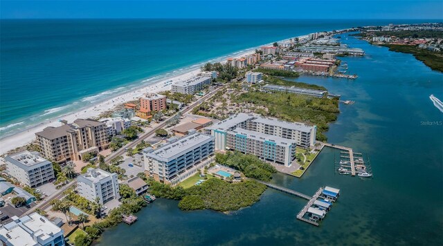 birds eye view of property featuring a water view and a beach view