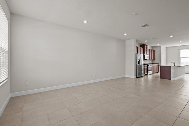 2432 Hearth Dr, Odessa, FL 33556 - unfurnished living room with a sink, recessed lighting, baseboards, and light tile patterned floors