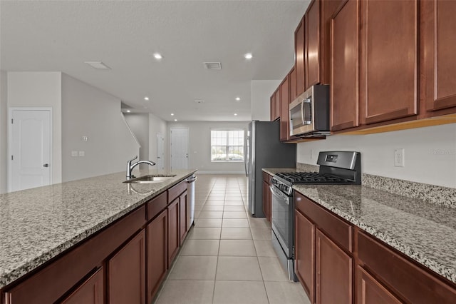 2432 Hearth Dr, Odessa, FL 33556 - kitchen featuring stainless steel appliances, a sink, light stone countertops, light tile patterned floors, and recessed lighting