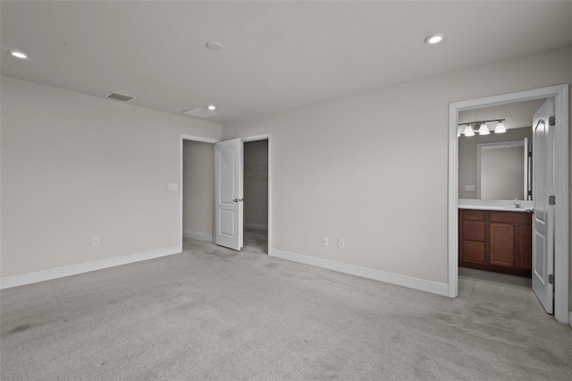 2432 Hearth Dr, Odessa, FL 33556 - unfurnished bedroom with light colored carpet, baseboards, recessed lighting, and a sink