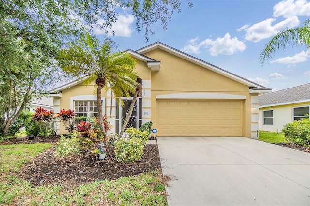 view of front of house featuring driveway, stucco siding, and a garage