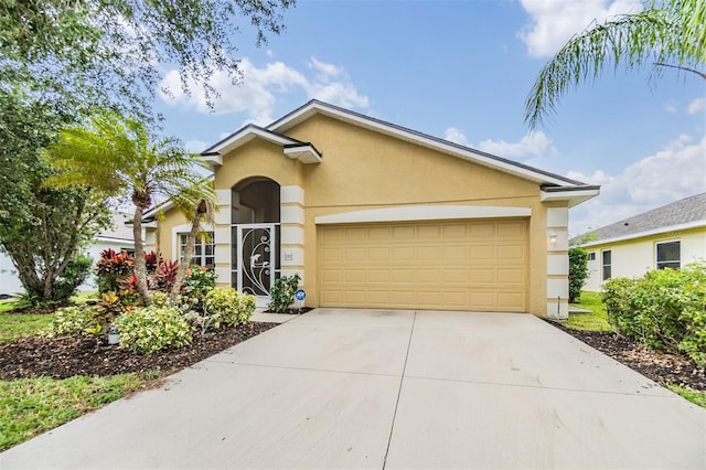 ranch-style home featuring an attached garage, stucco siding, and driveway