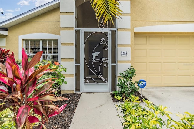 entrance to property featuring stucco siding