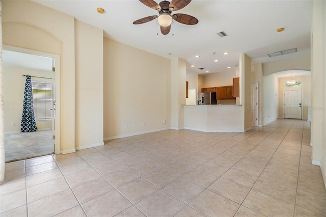 unfurnished living room with recessed lighting, light tile patterned floors, visible vents, ceiling fan, and arched walkways