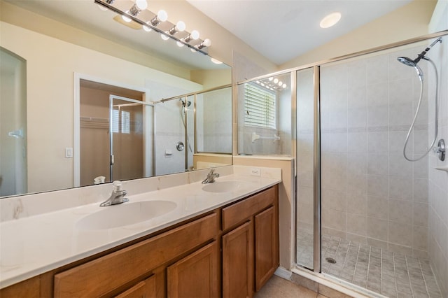 bathroom with a stall shower, double vanity, a sink, and vaulted ceiling