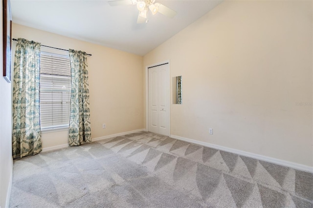 unfurnished room featuring baseboards, carpet flooring, ceiling fan, and vaulted ceiling