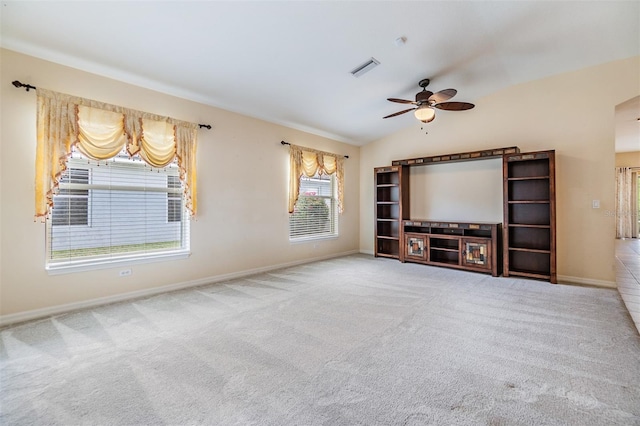 unfurnished living room featuring baseboards, carpet floors, a ceiling fan, and visible vents