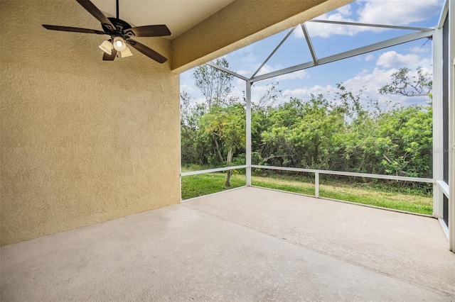 view of patio / terrace featuring ceiling fan and glass enclosure