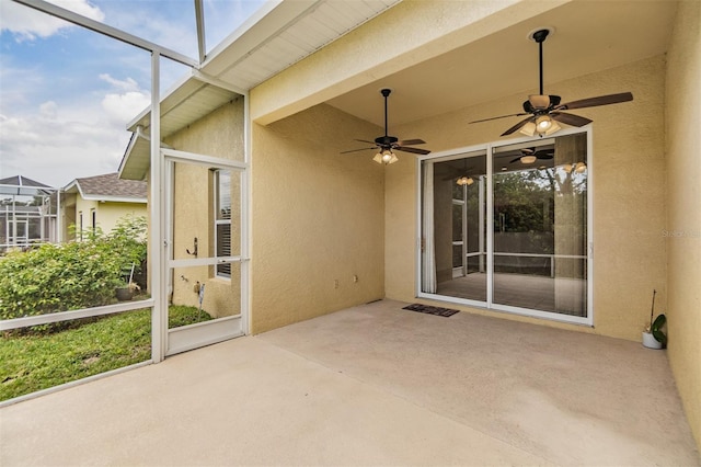 unfurnished sunroom featuring a wealth of natural light and ceiling fan