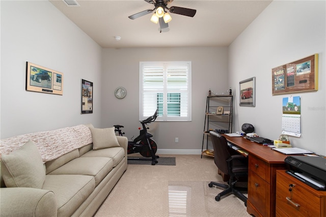 office area with light carpet, ceiling fan, and baseboards