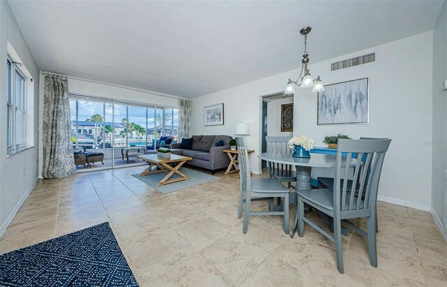 2186 Edythe Dr Unit 11, Dunedin, FL 34698 - dining space with baseboards and a chandelier