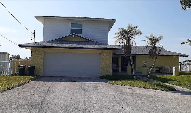 5930 Bahama Way N, St Pete Beach, FL 33706 - traditional-style house featuring driveway, stone siding, a shingled roof, and a garage