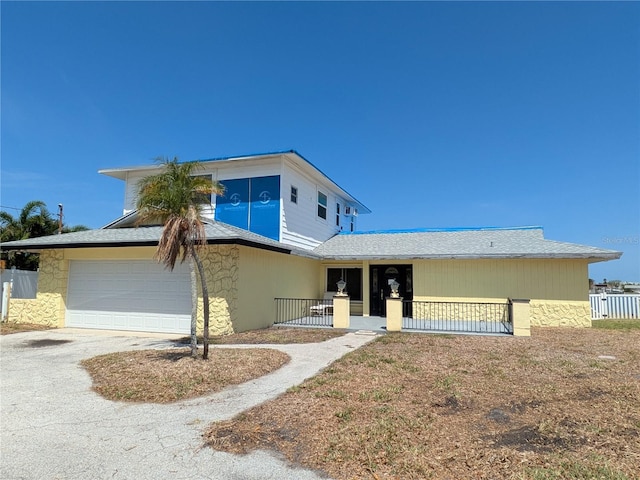 5930 Bahama Way N, St Pete Beach, FL 33706 - view of front of property with driveway, stone siding, and an attached garage