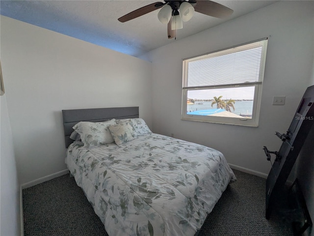 5930 Bahama Way N, St Pete Beach, FL 33706 - bedroom with carpet floors, baseboards, and a ceiling fan
