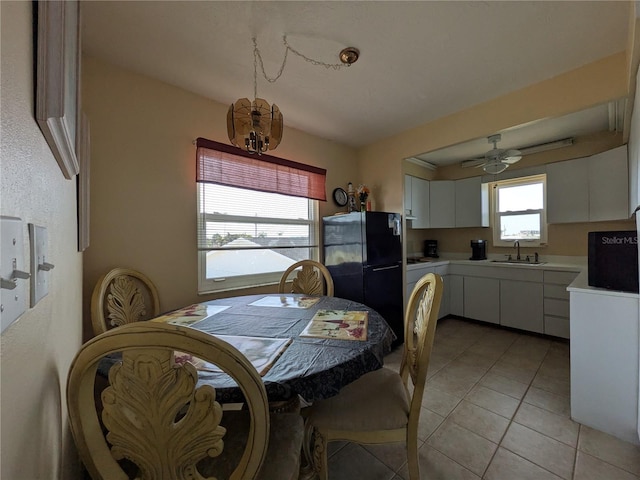 5930 Bahama Way N, St Pete Beach, FL 33706 - dining room with light tile patterned floors, ceiling fan, and a chandelier