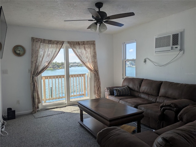5930 Bahama Way N, St Pete Beach, FL 33706 - carpeted living area with a wall unit AC, a ceiling fan, plenty of natural light, a water view, and a textured ceiling