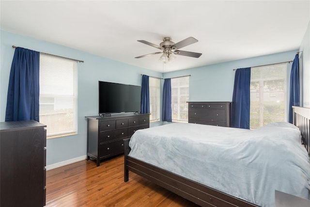 1310 Hilton Pl, Tampa, FL 33604 - bedroom with ceiling fan, baseboards, multiple windows, and wood finished floors