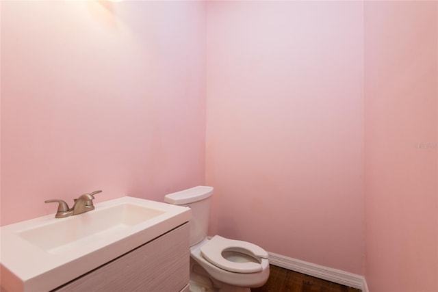 1310 Hilton Pl, Tampa, FL 33604 - bathroom featuring toilet, baseboards, vanity, and wood finished floors
