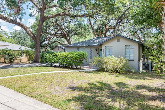 1310 Hilton Pl, Tampa, FL 33604 - single story home featuring a front lawn, stucco siding, and a gate