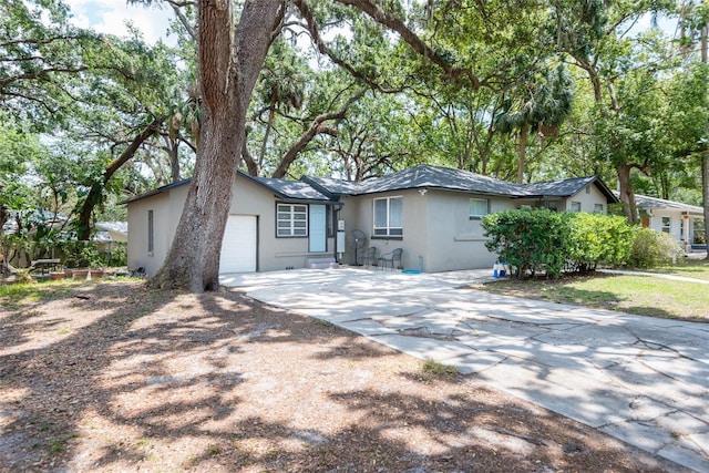 1310 Hilton Pl, Tampa, FL 33604 - single story home with stucco siding, driveway, and a garage