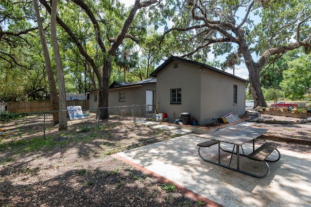 1310 Hilton Pl, Tampa, FL 33604 - rear view of house featuring fence, a patio, and stucco siding