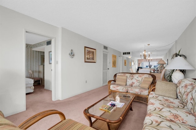 carpeted living area featuring an inviting chandelier and visible vents