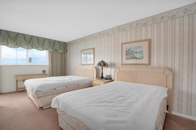 carpeted bedroom featuring baseboards, multiple windows, radiator, and wallpapered walls