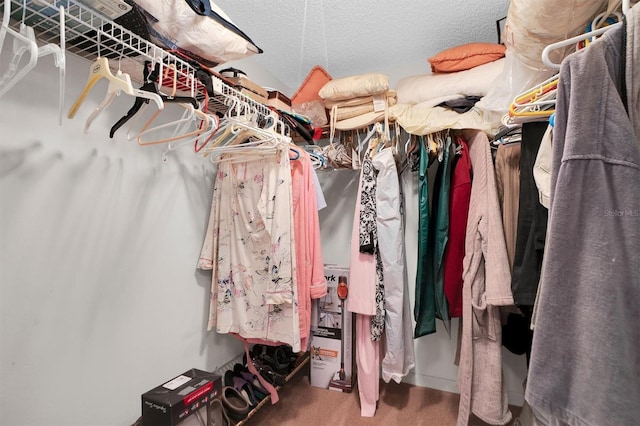 walk in closet with carpet