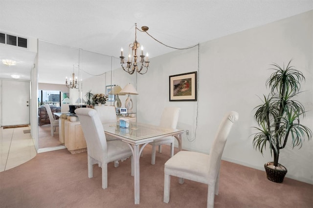 dining room featuring an inviting chandelier, light carpet, baseboards, and visible vents