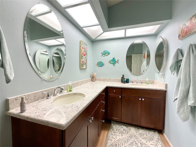 4740 Carrington Ct Unit 4740, New Port Richey, FL 34655 - full bath featuring a skylight, double vanity, and wood finished floors