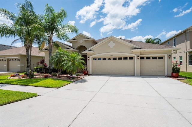 3300 Stonegate Falls Dr, Land O Lakes, FL 34638 - view of front facade with concrete driveway, stucco siding, and an attached garage