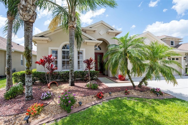 3300 Stonegate Falls Dr, Land O Lakes, FL 34638 - mediterranean / spanish-style home featuring concrete driveway, stucco siding, and a garage