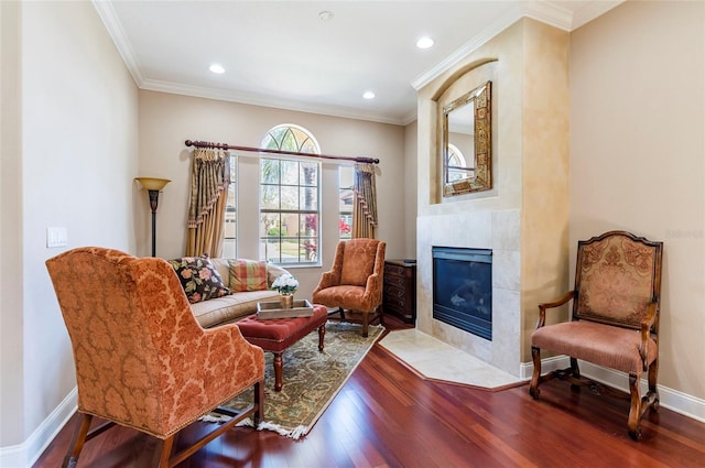 3300 Stonegate Falls Dr, Land O Lakes, FL 34638 - sitting room featuring wood finished floors, a tiled fireplace, crown molding, recessed lighting, and baseboards
