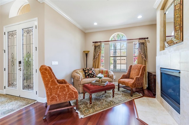 3300 Stonegate Falls Dr, Land O Lakes, FL 34638 - living area with wood finished floors, a fireplace, crown molding, recessed lighting, and baseboards