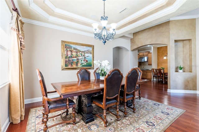 3300 Stonegate Falls Dr, Land O Lakes, FL 34638 - dining area featuring arched walkways, ornamental molding, a tray ceiling, dark wood-style flooring, and a chandelier