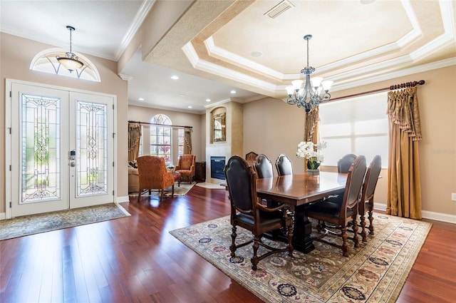 3300 Stonegate Falls Dr, Land O Lakes, FL 34638 - dining space featuring a chandelier, french doors, dark wood-type flooring, a raised ceiling, and crown molding