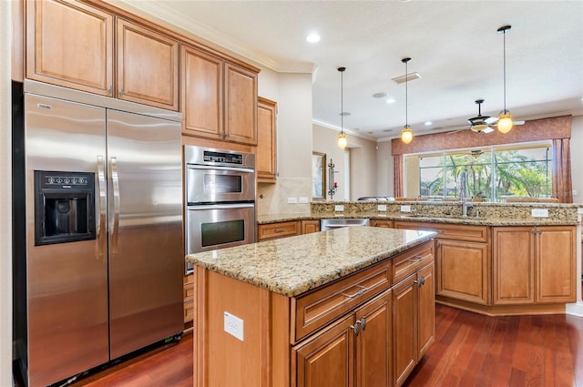 3300 Stonegate Falls Dr, Land O Lakes, FL 34638 - kitchen with stainless steel appliances, a sink, dark wood-type flooring, ornamental molding, and a kitchen island