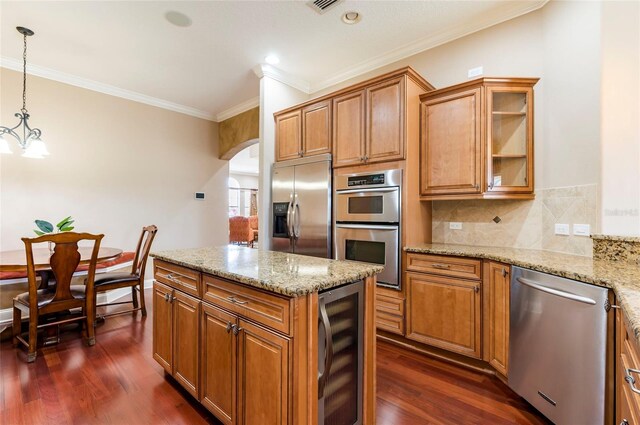 3300 Stonegate Falls Dr, Land O Lakes, FL 34638 - kitchen with beverage cooler, stainless steel appliances, arched walkways, ornamental molding, and dark wood-type flooring