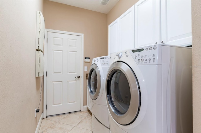 3300 Stonegate Falls Dr, Land O Lakes, FL 34638 - laundry room with washing machine and clothes dryer, cabinet space, light tile patterned flooring, and baseboards