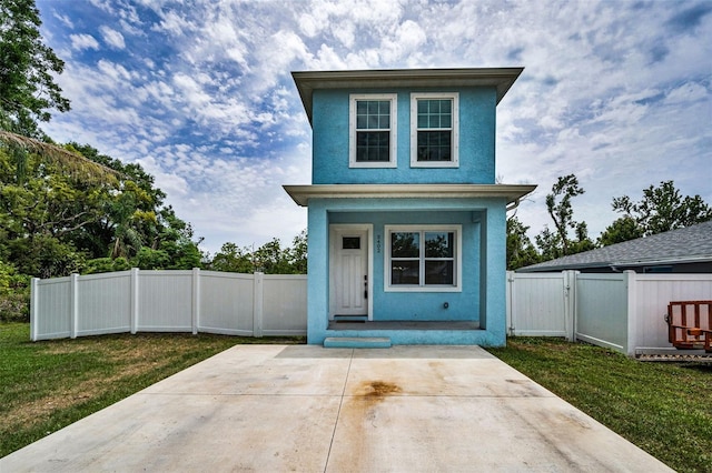 view of front of house featuring stucco siding and a porch