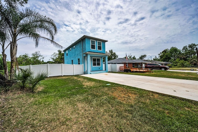 view of front facade with concrete driveway and stucco siding