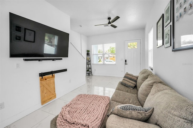 living room with baseboards, ceiling fan, and marble finish flooring