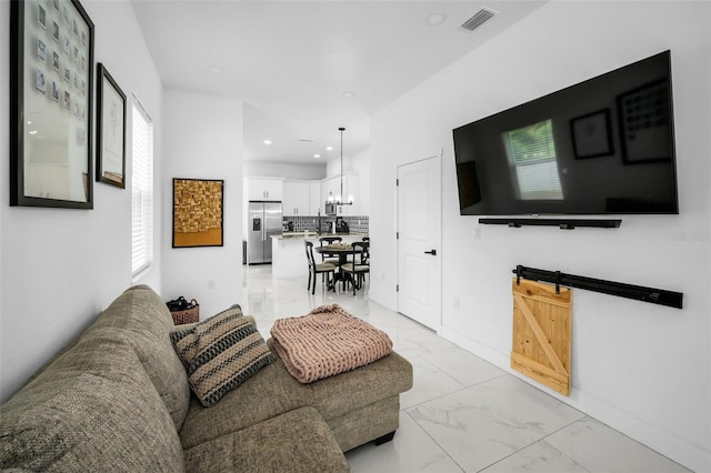 living room with light marble finish flooring, recessed lighting, and a chandelier